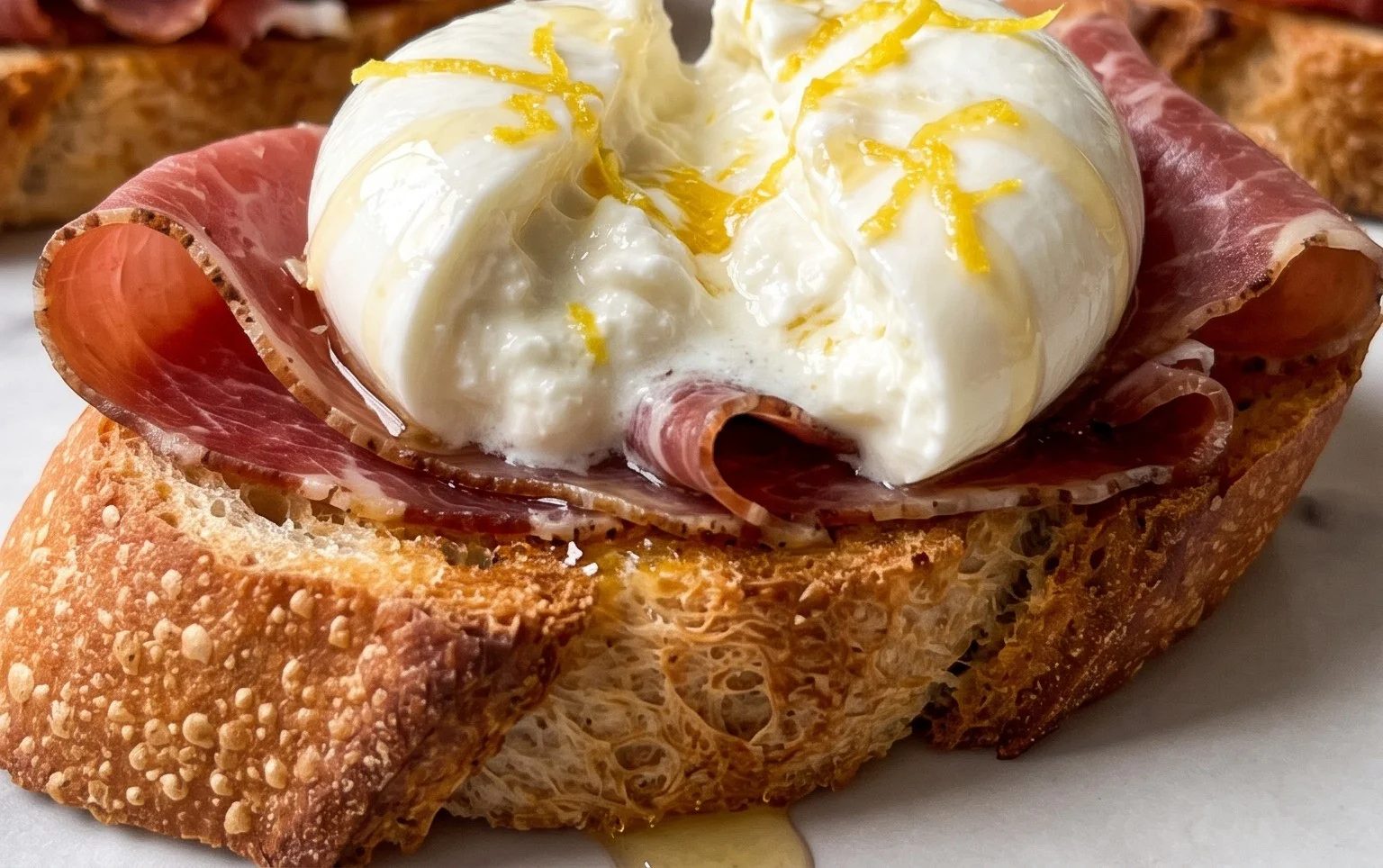 Beef Prosciutto Crostini with Burrata and Lemon Honey Drizzle