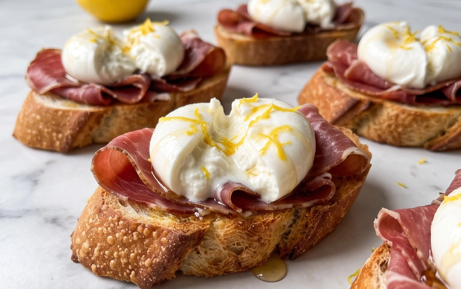 Beef Prosciutto Crostini with Burrata and Lemon Honey Drizzle